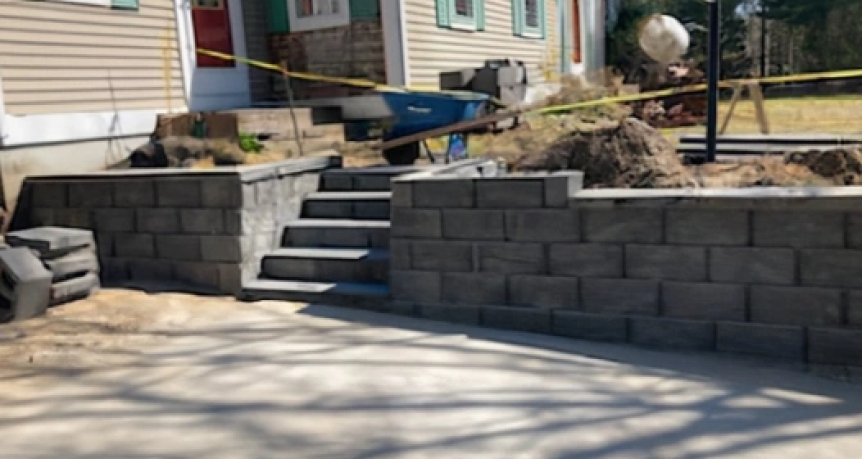 A beautifully constructed stone retaining wall, showcasing meticulous craftsmanship and natural stone textures, ideal for landscaping and erosion control.